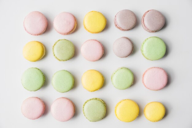 Row of macaroons on white backdrop