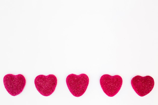 Row of sweet candies in form of hearts