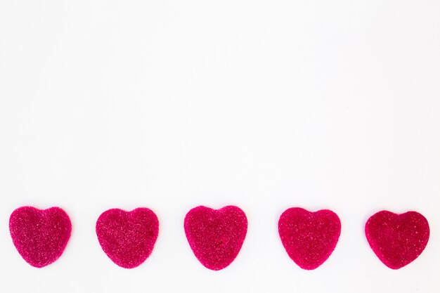 Row of sweet candies in form of hearts