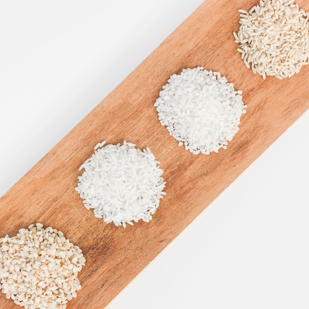 Row of various rice on wooden tray