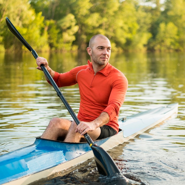 Rowing concept with man holding oar