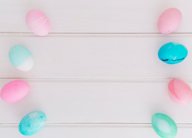 Rows of bright Easter eggs on desk