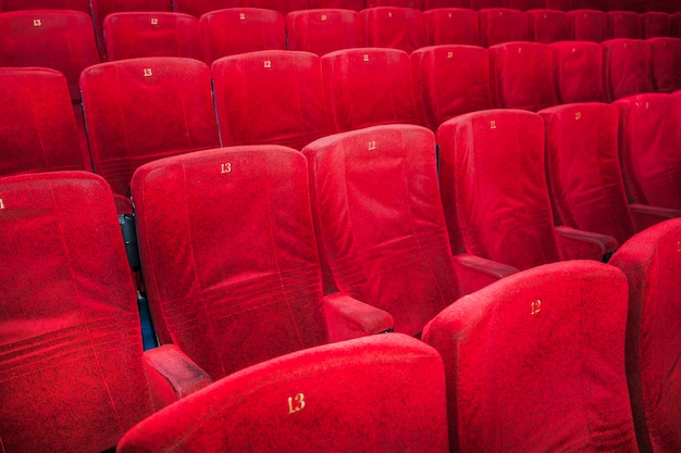 Rows of comfortable red chairs in cinema