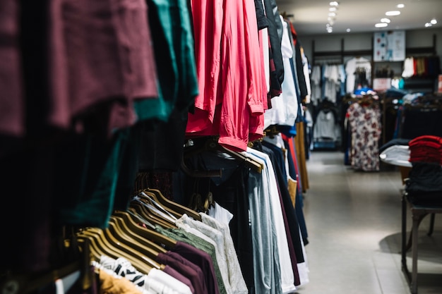 Free photo rows of hangers with clothes