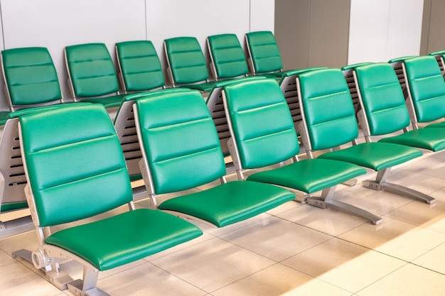 Rows of modern green chairs in waiting room