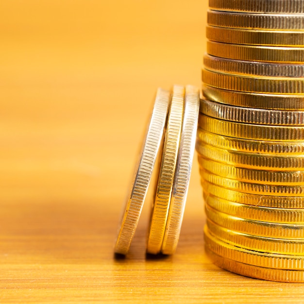 Rows, stacks of coins with blurred background and blank space