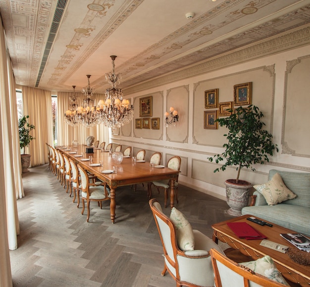 Royal dining room with wooden furniture and chandeliers