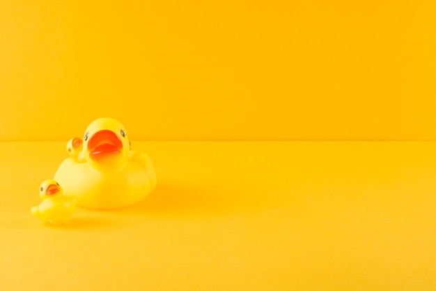 Rubber duck and ducklings on yellow backdrop