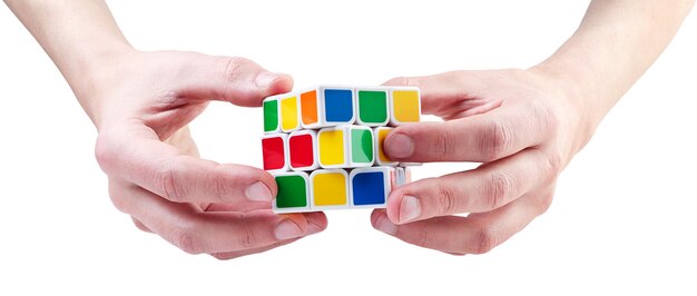 Rubik's cube in hands close-up on a white background. isolated