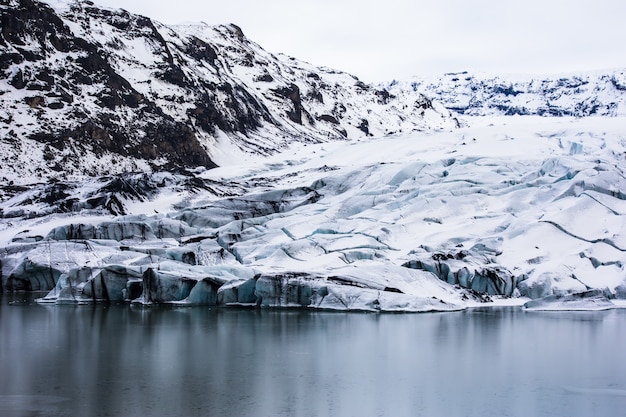 Rugged hillside and the frozen lake during wintertime