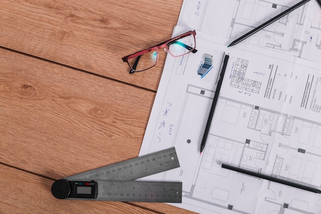 Ruler and glasses near blueprint