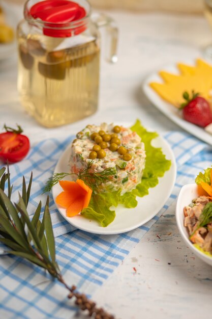 Russian salad olivie, stolichni with boiled vegetables, meat and grean beens   