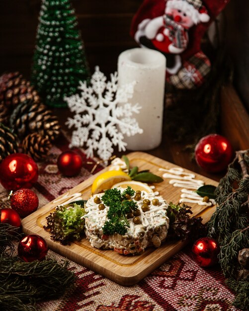 Russian salad topped with herbs and beans