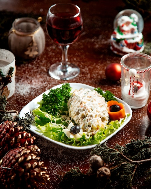 Russian salad with herbs and glass of wine