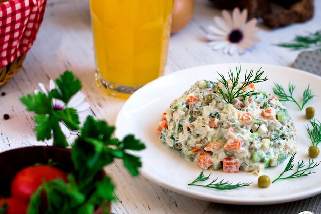 Free photo russian salad with herbs and orange juice