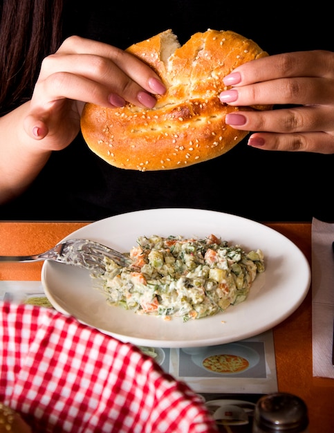 Russian salad with loaf of bread