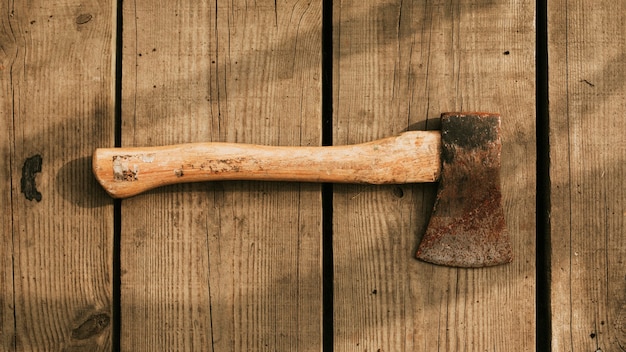 Rustic axe on a wooden background flatlay