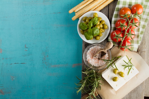 Rustic background with olives, cheese and tomatoes