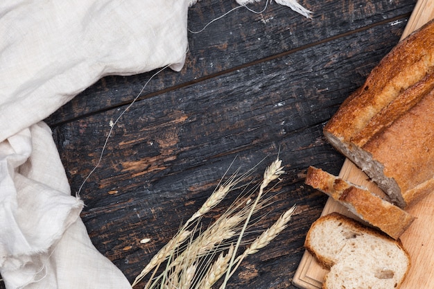 Бесплатное фото Деревенский хлеб на деревянный стол. темный древесный фон с пространством свободного текста.