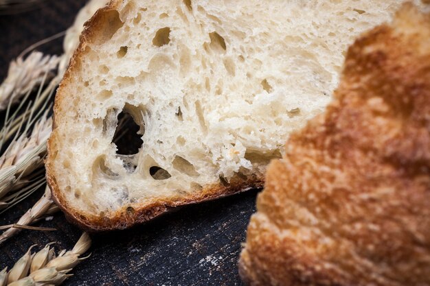 Rustic bread on wood table. Dark wooden background