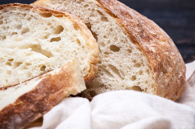 Rustic bread on wood table. Dark wooden space