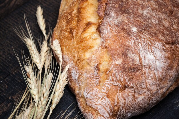 Rustic bread on wood table. Dark wooden space