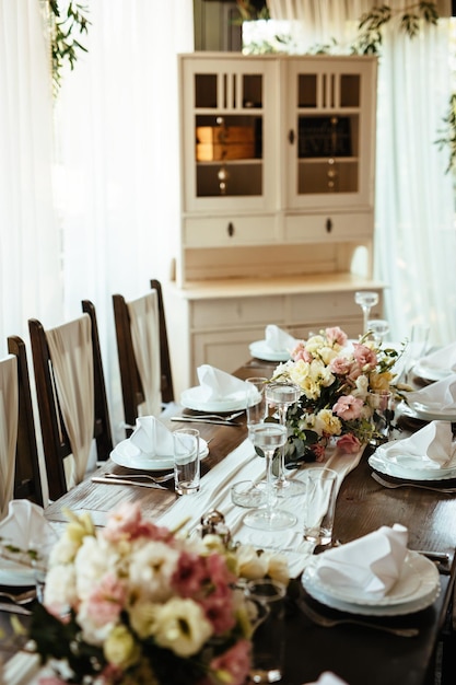 Rustic dining table setting at wedding venue.