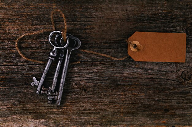 Rustic keys with label on wooden table