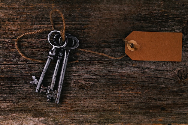 Rustic keys with label on wooden table