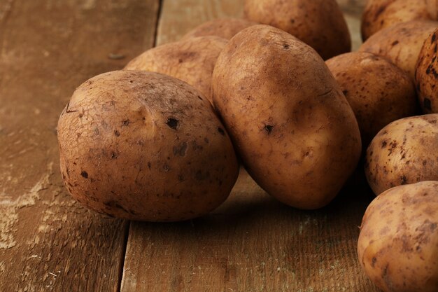 Rustic unpeeled potatoes on a desks