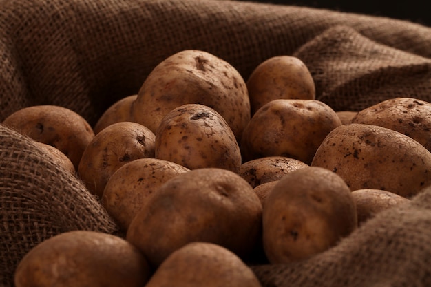 Rustic unpeeled potatoes on a desks