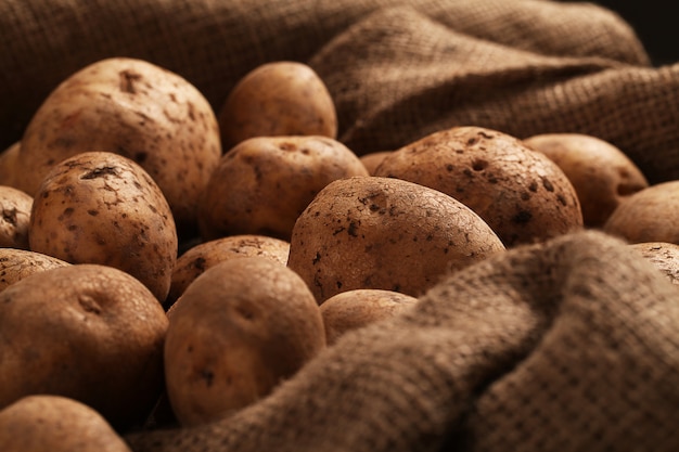 Rustic unpeeled potatoes on a desks