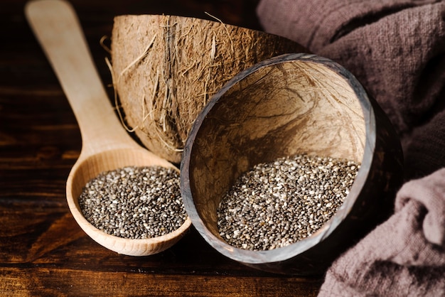 Rustic wooden spoon and bowl with seeds