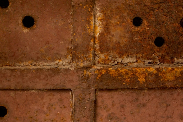 Rusty metal surface with solder and holes