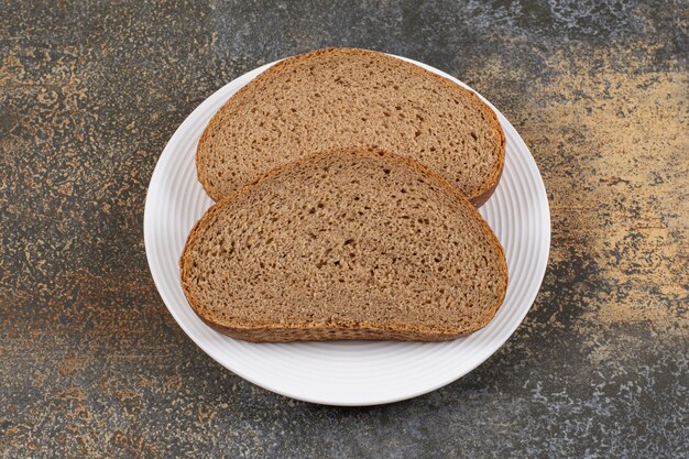 Rye bread slices on white plate.