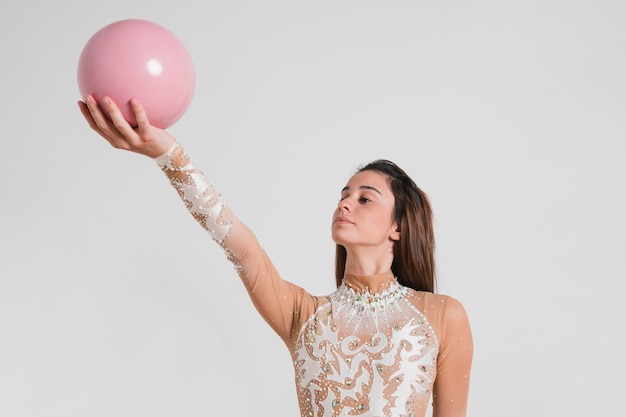 Free photo rythmic gymnast posing with the ball