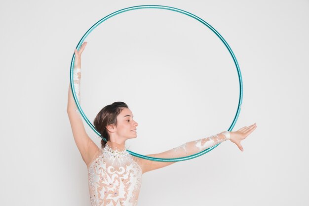 Rythmic gymnast posing with the hoop