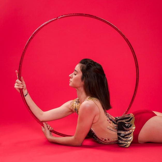 Free photo rythmic gymnast posing with the hoop