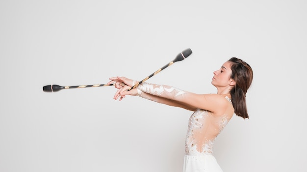 Free photo rythmic gymnast posing with the juggling clubs