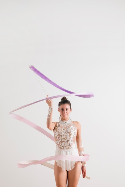 Rythmic gymnast posing with the ribbon