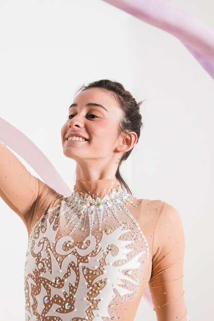 Rythmic gymnast posing with the ribbon