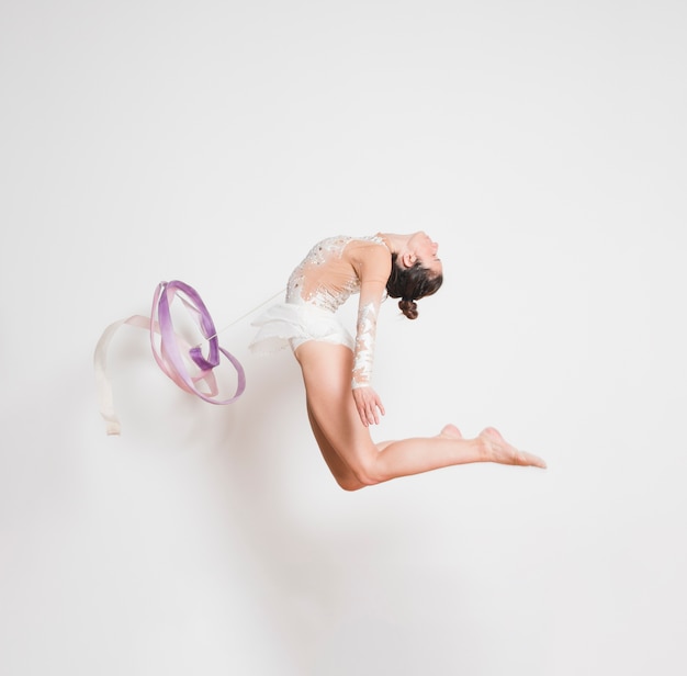 Rythmic gymnast posing with the ribbon
