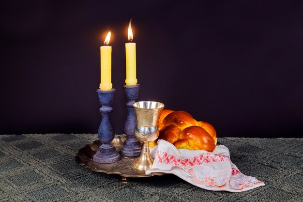 Premium Photo | Sabbath image. challah bread and candelas on wooden