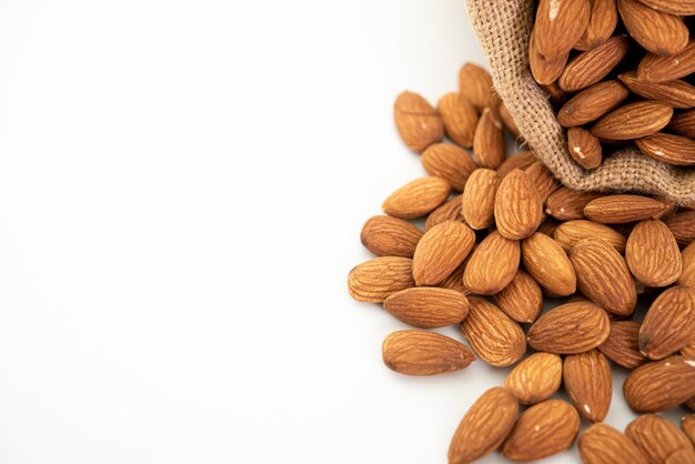 Sack with almond on white background.