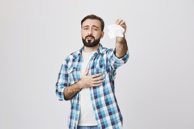 Sad adult man waving tissue saying goodbye