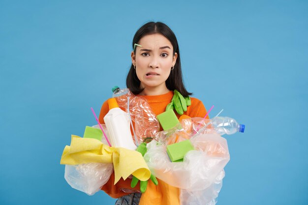 無料写真 悲しいアジアの女子学生がリサイクル廃棄物を保持し、プラスチックゴミを集めてリサイクルセンターに持ち込む