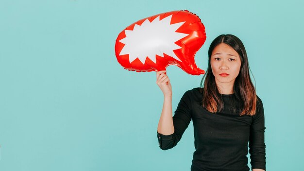 Sad Asian woman with speech balloon