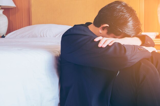 Sad business man sit in hotel room