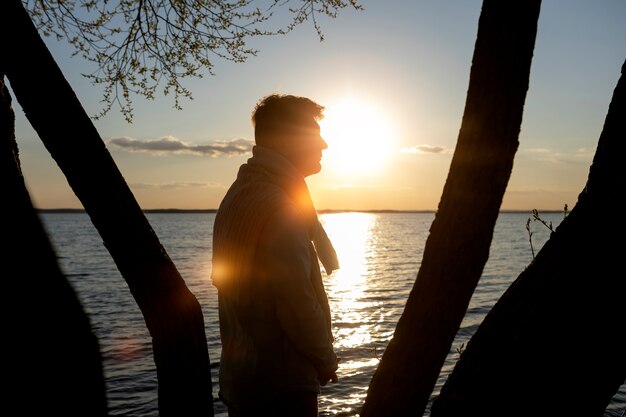 Sad and contemplative person near lake