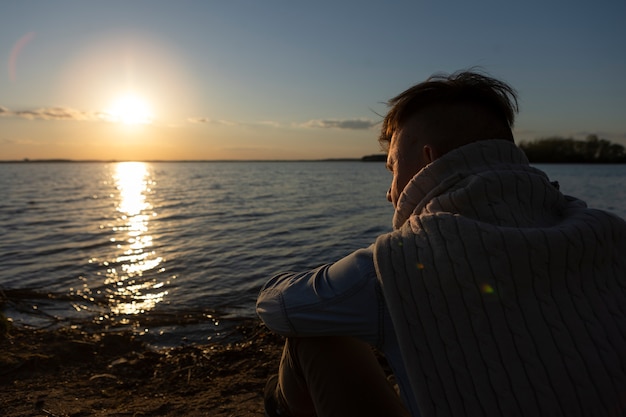 Free photo sad and contemplative person near lake